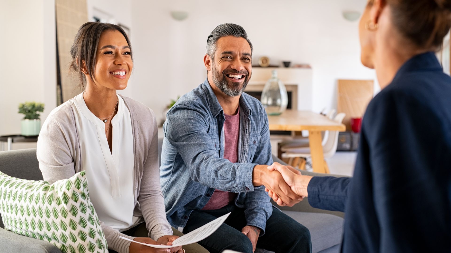 three people having a meeting. two people shaking hands
