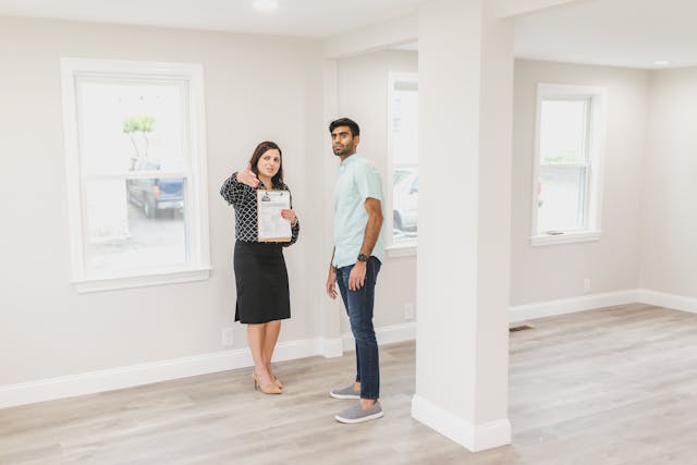 two people inspecting an empty unit