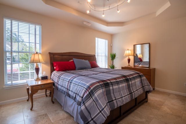 large bed with blue plaid bedding