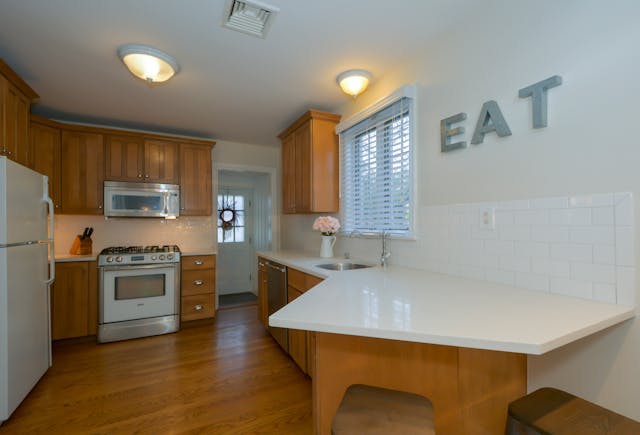 kitchen with white countertops and brown cupboards
