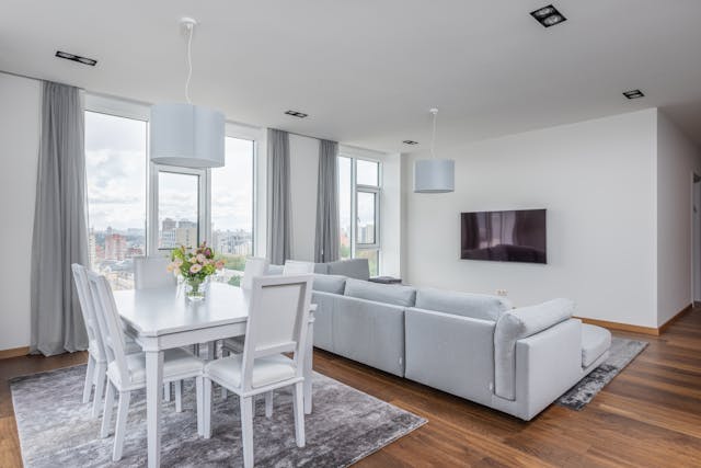 A kitchen table sitting behind a couch