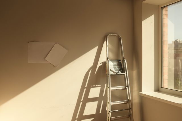A ladder sitting next to a window