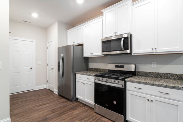 kitchen with whitecupboards and stainless steel appliances