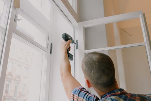 person putting up a new window