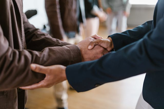 two investors shaking hands