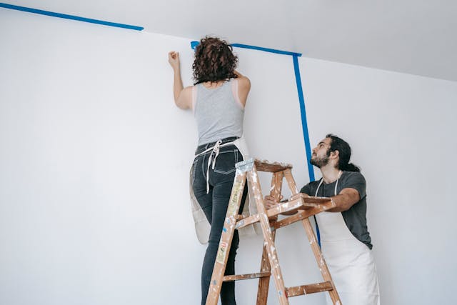 person placing painters tape
