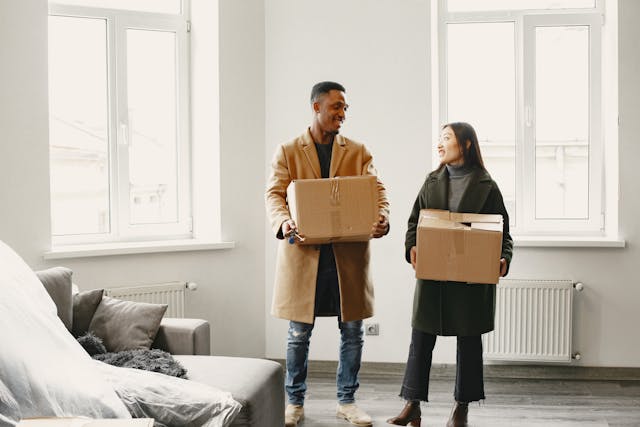 two people holding boxes
